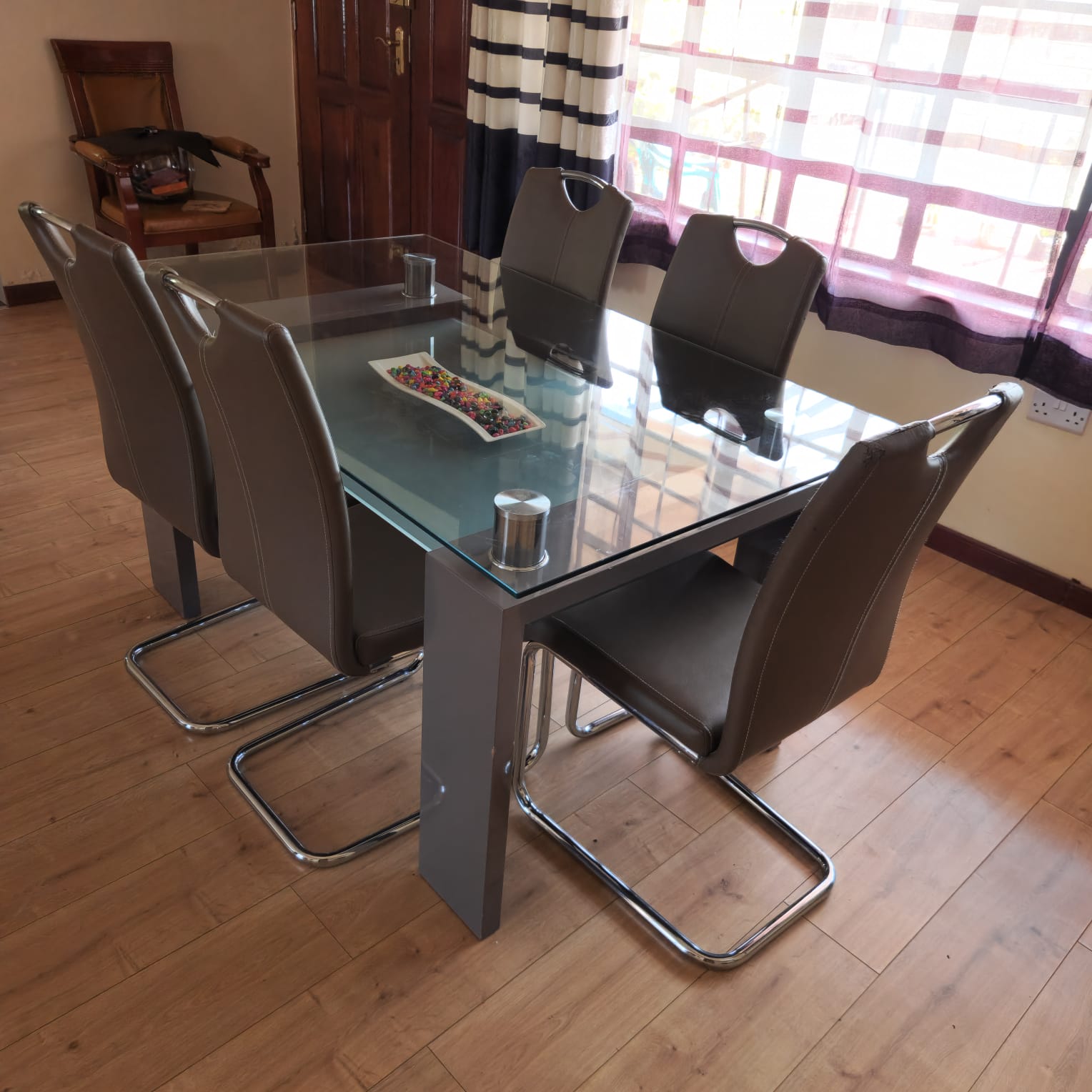 6-Seater Modern Glass Dining Table with Leather Chairs.