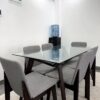 Modern Glass-Top Dining Set with Six Fabric Chairs